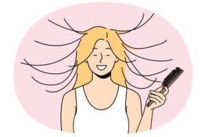 Let Loose Pink Brush -Woman combs hair and smiles, seeing effect of static magnetization of hairstyle.