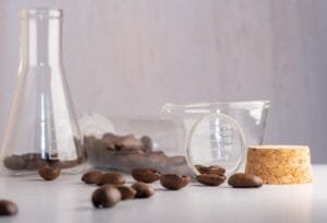 Close up shot of coffee beans in laboratory glassware being tested